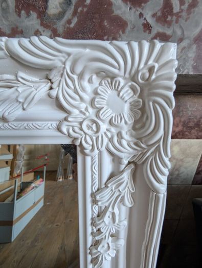 Ornate white wall mirror