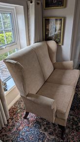 Newly upholstered Parker Knoll high-backed two-seater wingback settee
