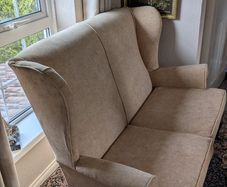 Newly upholstered Parker Knoll high-backed two-seater wingback settee