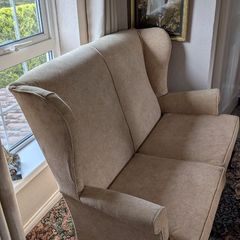 Newly upholstered Parker Knoll high-backed two-seater wingback settee