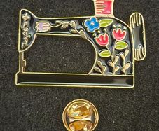 Sewing machine, pin back badge.