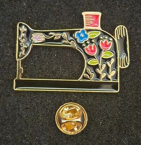 Sewing machine, pin back badge.
