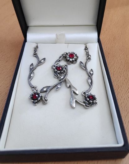 Silver tone floral necklace with red gemstone style accents