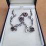 Silver tone floral necklace with red gemstone style accents Image 4