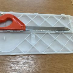 Folding chopping board and stainless steel knife.