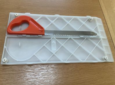 Folding chopping board and stainless steel knife.