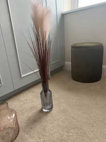blue glass vase with fluffy reeds