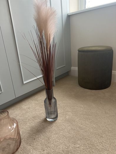 blue glass vase with fluffy reeds