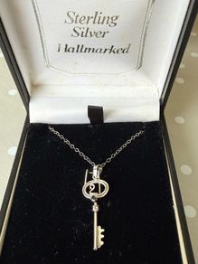 silver key on chain with genuine sapphire