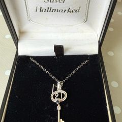 silver key on chain with genuine sapphire