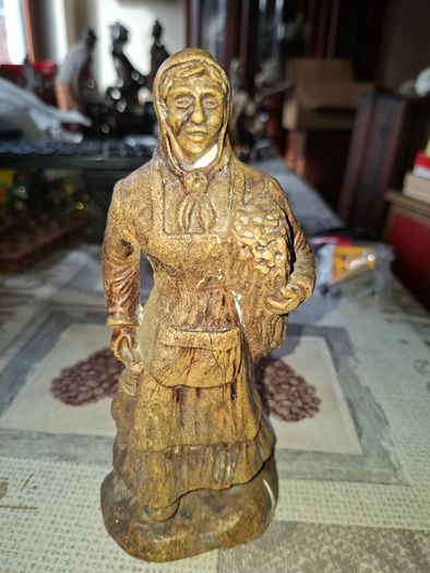 Peasant woman c1950s Wearing a Headscarf and Apron while carrying a bundle of provisions, features detailed facial expressions, textured clothing folds, and a base characteristic of regional decorative collectibles, Postage Available or Collection,