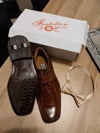 As new in box size 4 brown leather with bow tie also