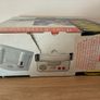 Boxed Amstrad GX4000 console with 2 controllers, cables, inserts, and pack-in game Image 4