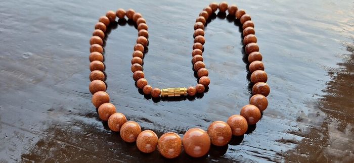 Gold sun stone necklace