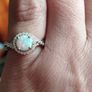 A beautiful 925 silver ring with a white lab opal surrounded by shining cubic zirconia. Image 4