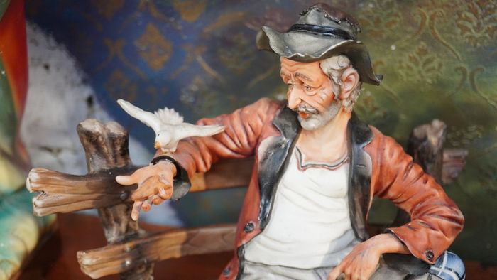 Porcelain Figurine of Seated Elderly Man with Birds