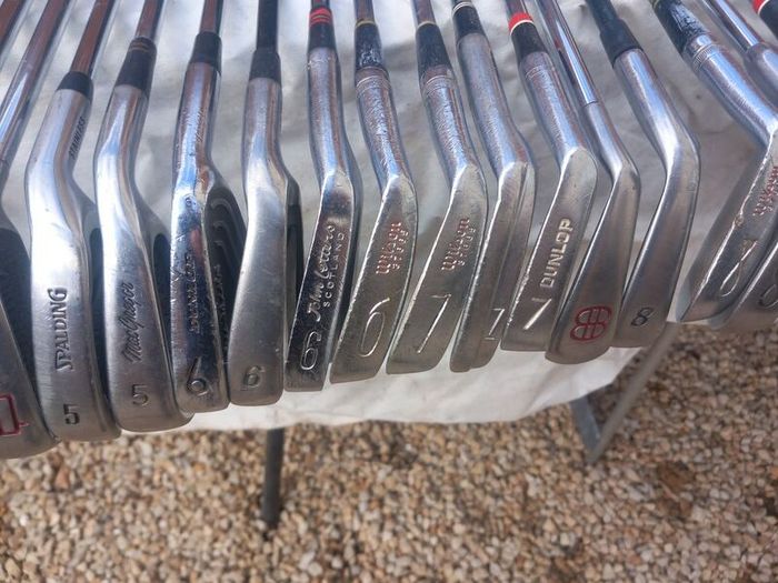 A selection of golf clubs and bags. Golf balls