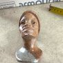 vintage image shows a handcrafted stone bust of a woman wearing a headscarf, often associated with Shona sculpture be carved from fruit serpentine stone from Zimbabwe Image 7