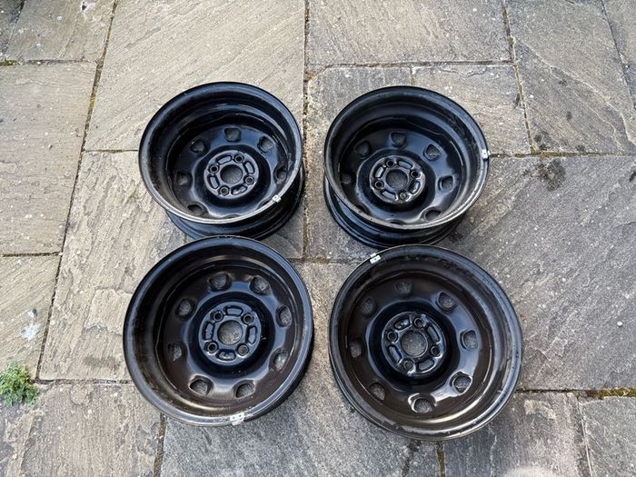 Four Black Steel Wheel Rims and Sixteen bolts