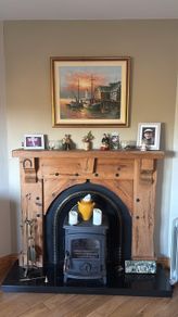 Timber surround with cast iron insert for fireplace