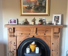 Timber surround with cast iron insert for fireplace