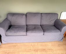 Two IKEA three-seater sofas and armchair
