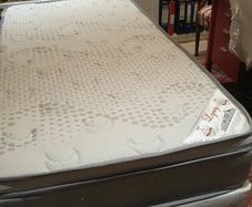 Single divan bed with pristine clean mattress and space for headboard