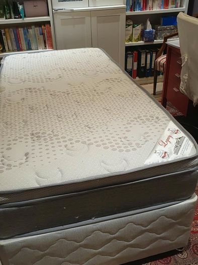 Single divan bed with pristine clean mattress and space for headboard