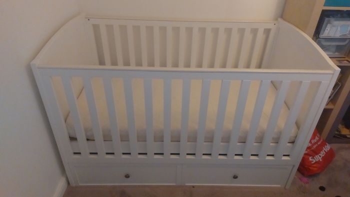 Cot that converts to toddler bed with underbed storage
