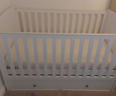 Cot that converts to toddler bed with underbed storage