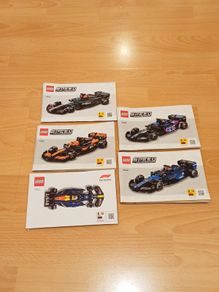 instruction booklets for five different LEGO Speed Champions Formula 1  race car building sets