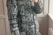 The North Face 700 Puffer Jacket in the "Black Logo Print" colorway