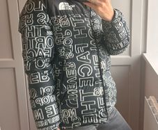 The North Face 700 Puffer Jacket in the "Black Logo Print" colorway