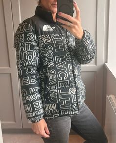 The North Face 700 Puffer Jacket in the "Black Logo Print" colorway