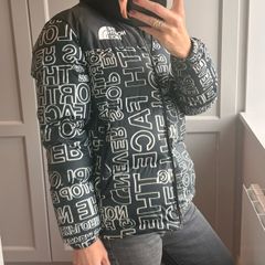 The North Face 700 Puffer Jacket in the "Black Logo Print" colorway