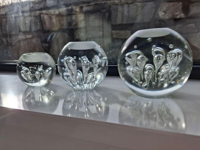 3 x cylindrical glass candle holders.