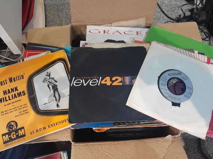a box of 7" singles. 45 rpm vinyl records.