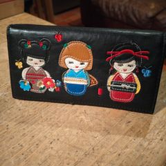 black faux leather wallet,featuring three embroidered Japanese Kokeshi doll