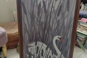 Vintage framed needlepoint tapestry depicting a white swan swimming