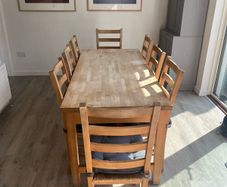 Solid oak dining table and 8 chairs with storage drawers
