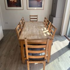 Solid oak dining table and 8 chairs with storage drawers