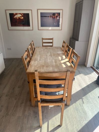 Solid oak dining table and 8 chairs with storage drawers