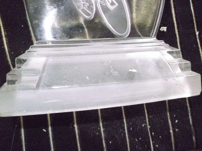 a cut glass with a cycle on it