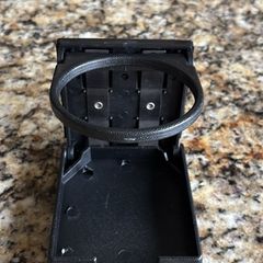 Bolt on foldable cup holder