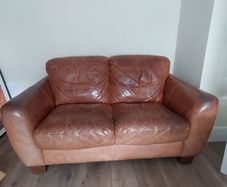 2 seater brown leather sofa. Approx 150cm width, approx 90cm breadth/ from back to front