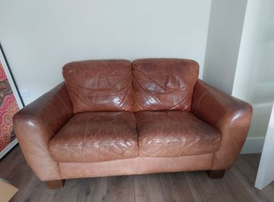 2 seater brown leather sofa. Approx 150cm width, approx 90cm breadth/ from back to front