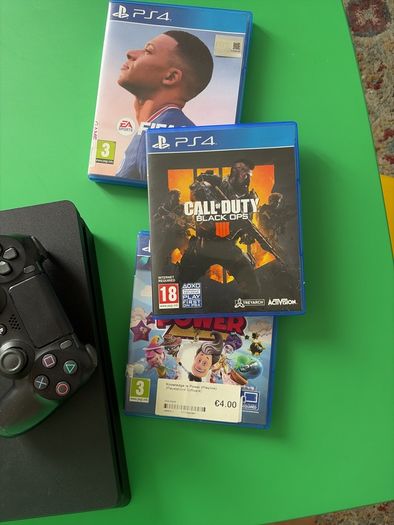 playstation 4 with two controllers and games