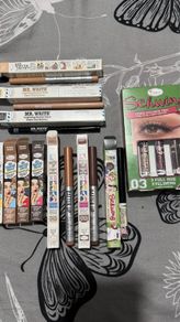 The balm tinted brow gel, clear brow gel, white, black eye pencils, liquid eyeliners