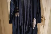 long-sleeved navy garment is an oversized graphic Jacket cardigan.