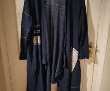 long-sleeved navy garment is an oversized graphic Jacket cardigan.